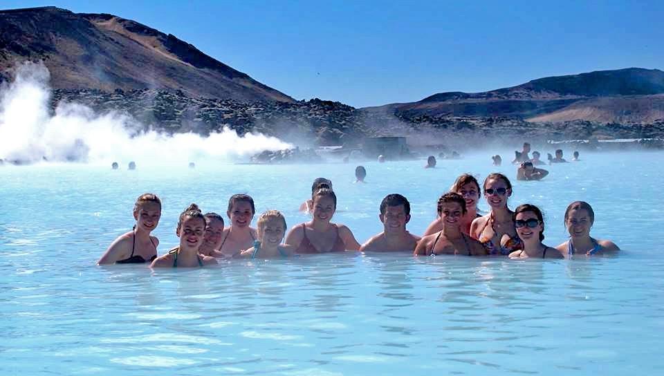 A goup of U N E students swimming in the Blue Lagoon geothermal spring